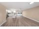 Bright, open-plan living room with hardwood floors flowing into a modern kitchen and a seamless indoor-outdoor layout at 239 Freeport Ne Ave, St Petersburg, FL 33702