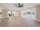 Expansive living room featuring a bay window, fireplace, and sliding doors to the screened porch at 239 Freeport Ne Ave, St Petersburg, FL 33702