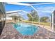 Sparkling pool surrounded by brick pavers and enclosed by a white screen, offering a relaxing outdoor experience at 239 Freeport Ne Ave, St Petersburg, FL 33702