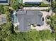 Expansive property with dark grey roof, lush foliage and inground pool; viewed from above at 2902 W Fair Oaks Ave, Tampa, FL 33611