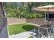 Inviting backyard with artificial grass, brick wall, and outdoor seating area, perfect for relaxing and entertaining at 2902 W Fair Oaks Ave, Tampa, FL 33611