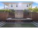 Elegant backyard water fountain with unique tilework, lush greenery, and manicured lawn at 2902 W Fair Oaks Ave, Tampa, FL 33611