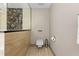 Modern bathroom featuring a toilet, towel rack, and gray walls at 2902 W Fair Oaks Ave, Tampa, FL 33611