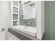 Stylish bathroom featuring a modern sink, chrome faucet, large mirror, and decorative shelves for a sleek look at 2902 W Fair Oaks Ave, Tampa, FL 33611