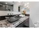 Modern bathroom features an eye-catching vessel sink, granite countertop, and a sleek, tiled backsplash at 2902 W Fair Oaks Ave, Tampa, FL 33611