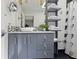 Modern bathroom features a vessel sink, gray cabinetry with square hardware, and open shelving at 2902 W Fair Oaks Ave, Tampa, FL 33611