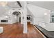 Large bathroom featuring a soaking tub, hardwood floors, a crystal chandelier, and an arched doorway at 2902 W Fair Oaks Ave, Tampa, FL 33611