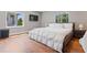 Bright bedroom featuring hardwood floors, large windows, and a modern TV for comfortable relaxation at 2902 W Fair Oaks Ave, Tampa, FL 33611