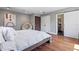 Cozy bedroom with a comfortable bed, stylish art, and convenient access to the en-suite bathroom at 2902 W Fair Oaks Ave, Tampa, FL 33611