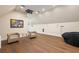 Spacious bonus room featuring projector, hardwood floors, recessed lighting, and stylish decor elements at 2902 W Fair Oaks Ave, Tampa, FL 33611