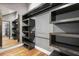 Modern closet with dark wood shelving, hanging rods, and a full-length mirror on a wooden floor at 2902 W Fair Oaks Ave, Tampa, FL 33611