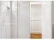 Well-lit walk-in closet featuring white shelving, hardwood floors, and modern recessed lighting at 2902 W Fair Oaks Ave, Tampa, FL 33611
