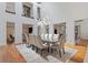 Spacious dining room with high ceilings, modern lighting, seating for ten, and access to other areas of the home at 2902 W Fair Oaks Ave, Tampa, FL 33611