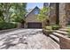Spacious driveway leading to the home's garage, bordered by manicured hedges and mature trees at 2902 W Fair Oaks Ave, Tampa, FL 33611