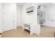 Welcoming entryway with spiral staircase, bench seating, and built-in storage shelves for added convenience at 2902 W Fair Oaks Ave, Tampa, FL 33611