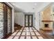 Inviting foyer with decorative tile, hardwood floors, and a statement fireplace at 2902 W Fair Oaks Ave, Tampa, FL 33611