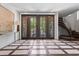 Grand foyer with unique tile design, modern staircase, and stylish double doors at 2902 W Fair Oaks Ave, Tampa, FL 33611