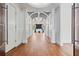 Grand hallway featuring wood floors, white columns, a decorative ceiling, and doors with silver handles at 2902 W Fair Oaks Ave, Tampa, FL 33611