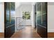 Bright hallway with wooden floor and eye-catching glass sliding doors that let in plenty of light at 2902 W Fair Oaks Ave, Tampa, FL 33611