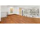 Hallway with hardwood floors and stainless steel railings, providing a modern and open feel to the space at 2902 W Fair Oaks Ave, Tampa, FL 33611