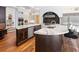 Expansive kitchen featuring marble countertops, dark wood accents, stainless steel appliances, and barstool seating at 2902 W Fair Oaks Ave, Tampa, FL 33611