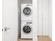 Compact laundry room with stackable washer and dryer units and built-in storage cabinets, maximizing space at 2902 W Fair Oaks Ave, Tampa, FL 33611