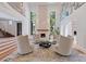 Elegant living room with two-story ceilings, large windows, fireplace, stylish seating, and modern decor at 2902 W Fair Oaks Ave, Tampa, FL 33611