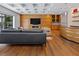 Modern living room features a wood-paneled accent wall with fireplace and sleek wood floors at 2902 W Fair Oaks Ave, Tampa, FL 33611