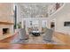 Bright living room featuring a stone fireplace, modern decor, and hardwood floors at 2902 W Fair Oaks Ave, Tampa, FL 33611