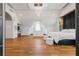 Spacious primary bedroom with a crystal chandelier, hardwood flooring, and ample natural light at 2902 W Fair Oaks Ave, Tampa, FL 33611