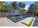 Beautiful backyard pool and spa with waterfall features, lush landscaping, and stylish outdoor seating at 2902 W Fair Oaks Ave, Tampa, FL 33611