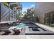 Stunning pool area with a waterfall feature, modern lounge chairs, and lush landscaping for a resort-like experience at 2902 W Fair Oaks Ave, Tampa, FL 33611