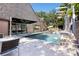 Gorgeous backyard pool with elegant brickwork, sleek outdoor furniture, and lush tropical greenery at 2902 W Fair Oaks Ave, Tampa, FL 33611