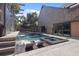 Luxury pool area with a hot tub, waterfall feature, lounge chairs, and modern landscaping for ultimate relaxation at 2902 W Fair Oaks Ave, Tampa, FL 33611