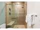 Modern shower with a glass door, tiled walls, mosaic accents, and a built-in bench for comfortable bathing at 2902 W Fair Oaks Ave, Tampa, FL 33611