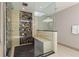 Walk-in shower with stone and wood paneling, dual shower heads, and a built-in bench at 2902 W Fair Oaks Ave, Tampa, FL 33611