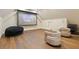 Cozy theater room featuring a projection screen, hardwood floors, a comfortable beanbag, and plush chairs at 2902 W Fair Oaks Ave, Tampa, FL 33611
