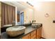 Bathroom boasting double sinks with rock basins and wood cabinets at 2969 La Concha Dr, Clearwater, FL 33762