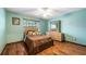 Bedroom featuring hardwood floors, a large window, dresser, and ceiling fan at 2969 La Concha Dr, Clearwater, FL 33762