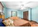 Well-lit bedroom with hardwood floors, ceiling fan, and double door closet at 2969 La Concha Dr, Clearwater, FL 33762