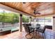 Covered patio with a dining table, a ceiling fan, and an outdoor kitchen with a grill at 2969 La Concha Dr, Clearwater, FL 33762