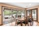 Dining room featuring tile flooring, sliding glass doors to the patio and a wooden table with six chairs at 2969 La Concha Dr, Clearwater, FL 33762