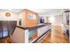 Open hallway featuring hardwood floors, interior windows, and a staircase at 2969 La Concha Dr, Clearwater, FL 33762