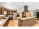 Well-appointed kitchen with granite counters, stainless appliances, dark wood cabinets, and terracotta tile flooring at 2969 La Concha Dr, Clearwater, FL 33762
