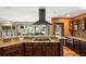 An open kitchen showcasing custom cabinetry, sleek appliances, granite countertops, and a breakfast bar at 2969 La Concha Dr, Clearwater, FL 33762