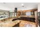 Spacious kitchen featuring dark wood cabinetry, granite countertops, stainless steel appliances, and terracotta tile flooring at 2969 La Concha Dr, Clearwater, FL 33762