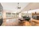 Bright living room featuring hardwood floors, fireplace, ceiling fan and sliding glass doors to outside dining area at 2969 La Concha Dr, Clearwater, FL 33762