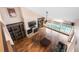 Spacious living room with hardwood floors, stone fireplace, vaulted ceilings, and large windows overlooking the pool at 2969 La Concha Dr, Clearwater, FL 33762