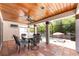 A covered patio featuring an outdoor dining area, and access to the pool and deck chairs at 2969 La Concha Dr, Clearwater, FL 33762