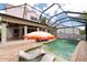Back of house featuring screened in pool, spa and stone pavers at 2969 La Concha Dr, Clearwater, FL 33762
